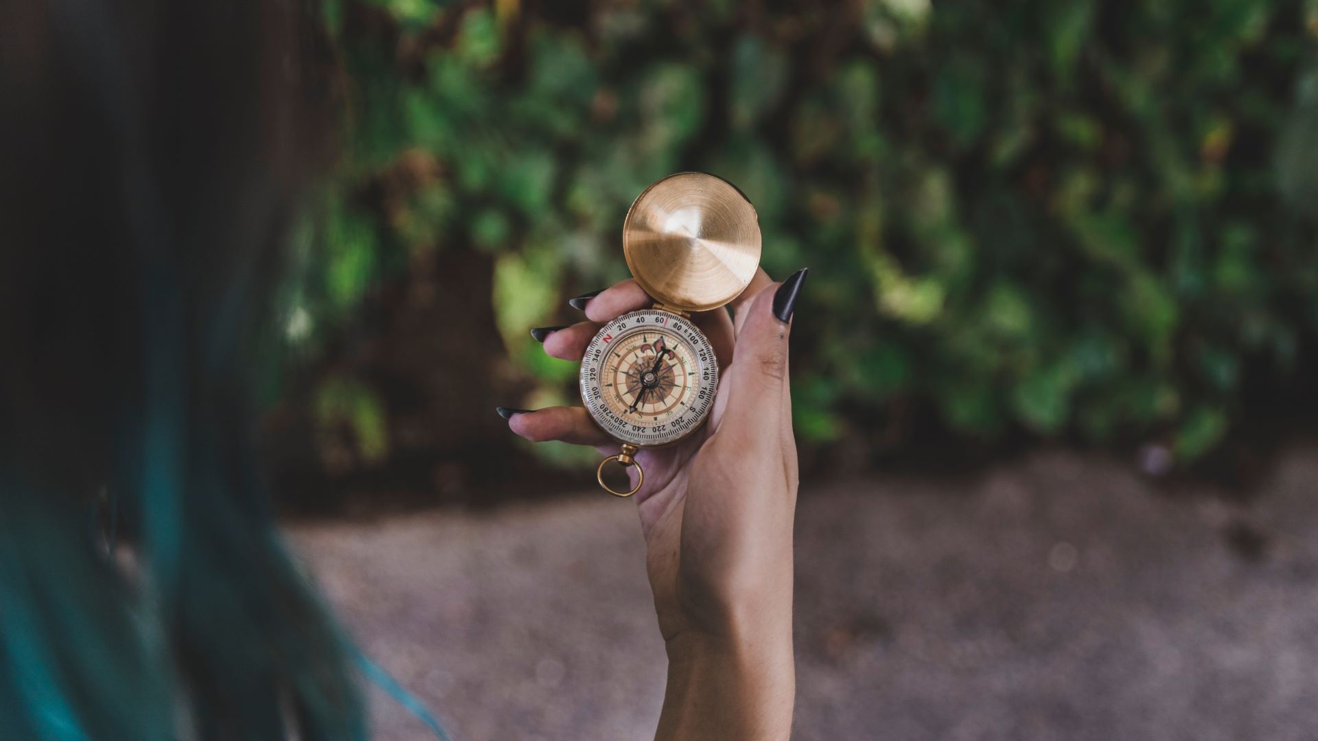 woman-looking-golden-vintage-compass-hand (1)